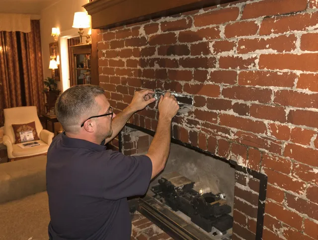 Shaker Heights Chimney Sweep expert fixing a fireplace in Shaker Heights, OH